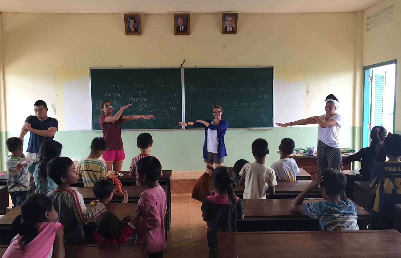 A group of students leading elementary schoolers in a class exercise