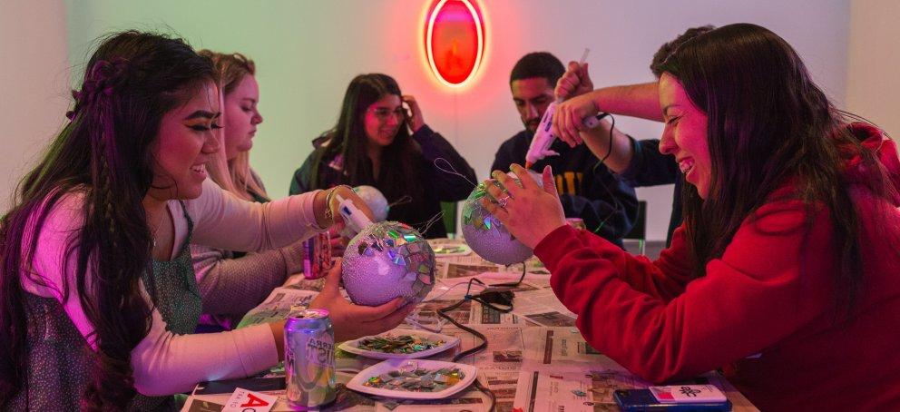 students working on disco ball in musuem 