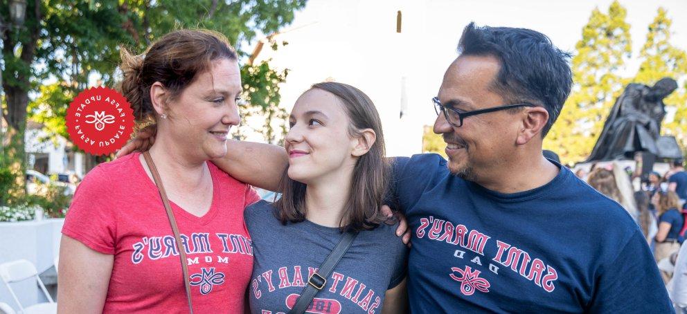 three proud family members looking at eachother