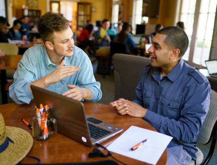 A wrtier and a Writing Adviser discussing a paper in the Writing Center