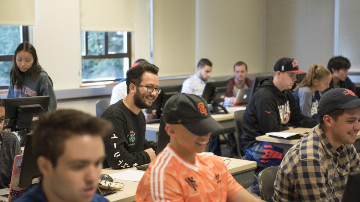 Students in a computer lab smiling 